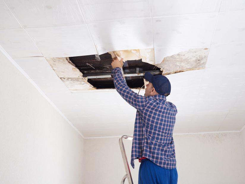 Photo of a Man Repairing Ceiling