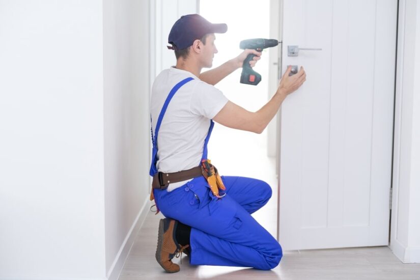 Photo of a repairman fixing the door handle