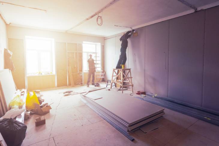 Photo of two people restoring a room