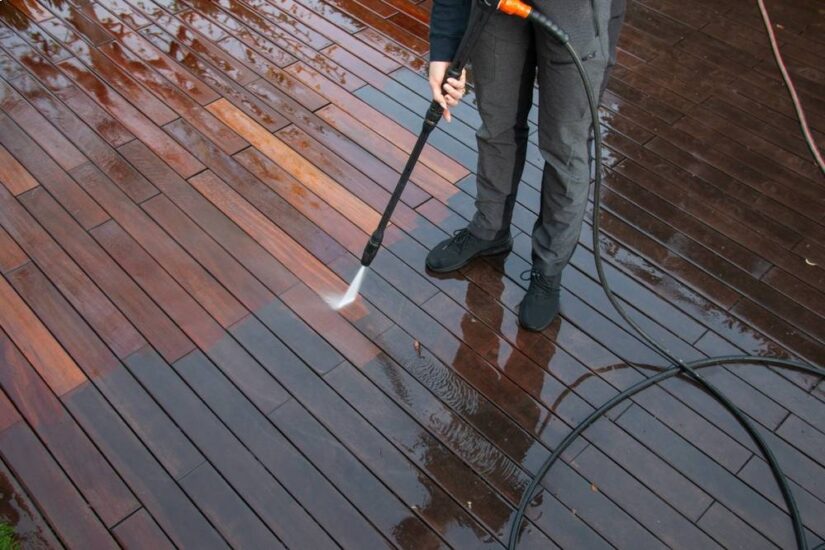 Photo of man washing deck during repair